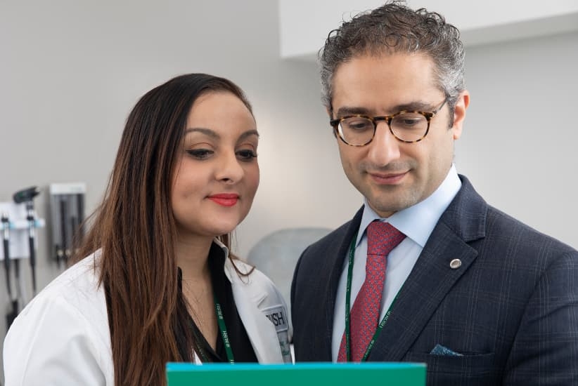 Dr. Dorafshar and Dr. Shenaq reviewing a medical record